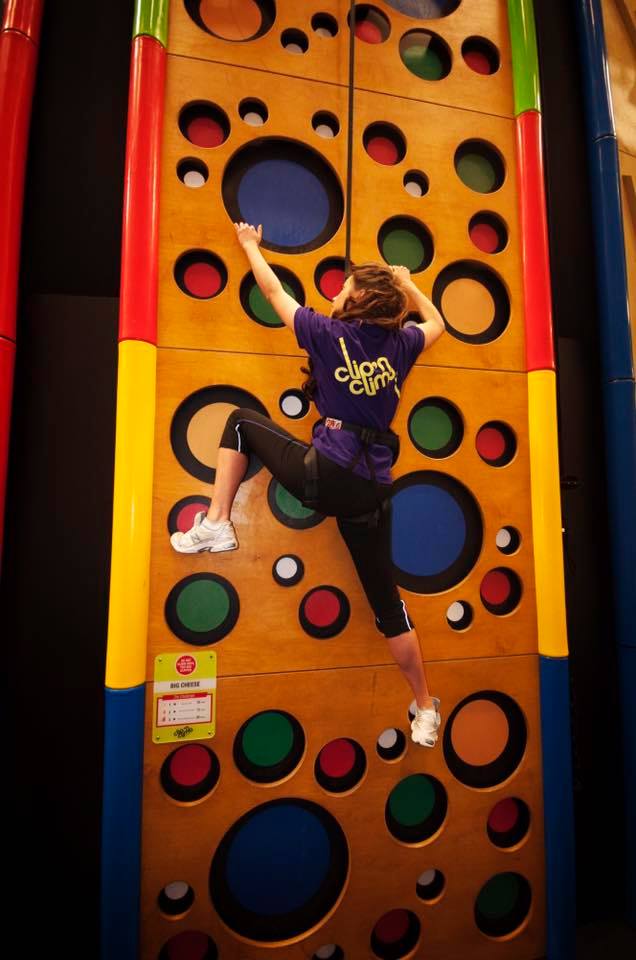 Girl on kids climbing wall