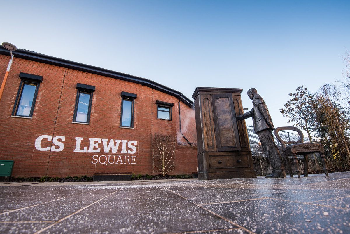 Statue of C.S Lewis beside wardrobe at C.S Lewis square