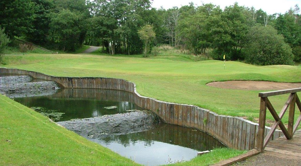 Golf course with water hazard in foreground