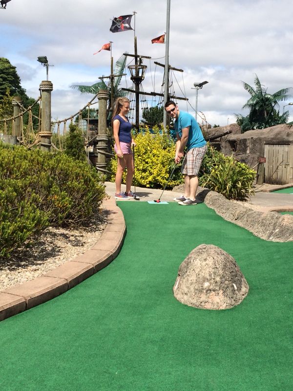 Man and woman playing mini golf