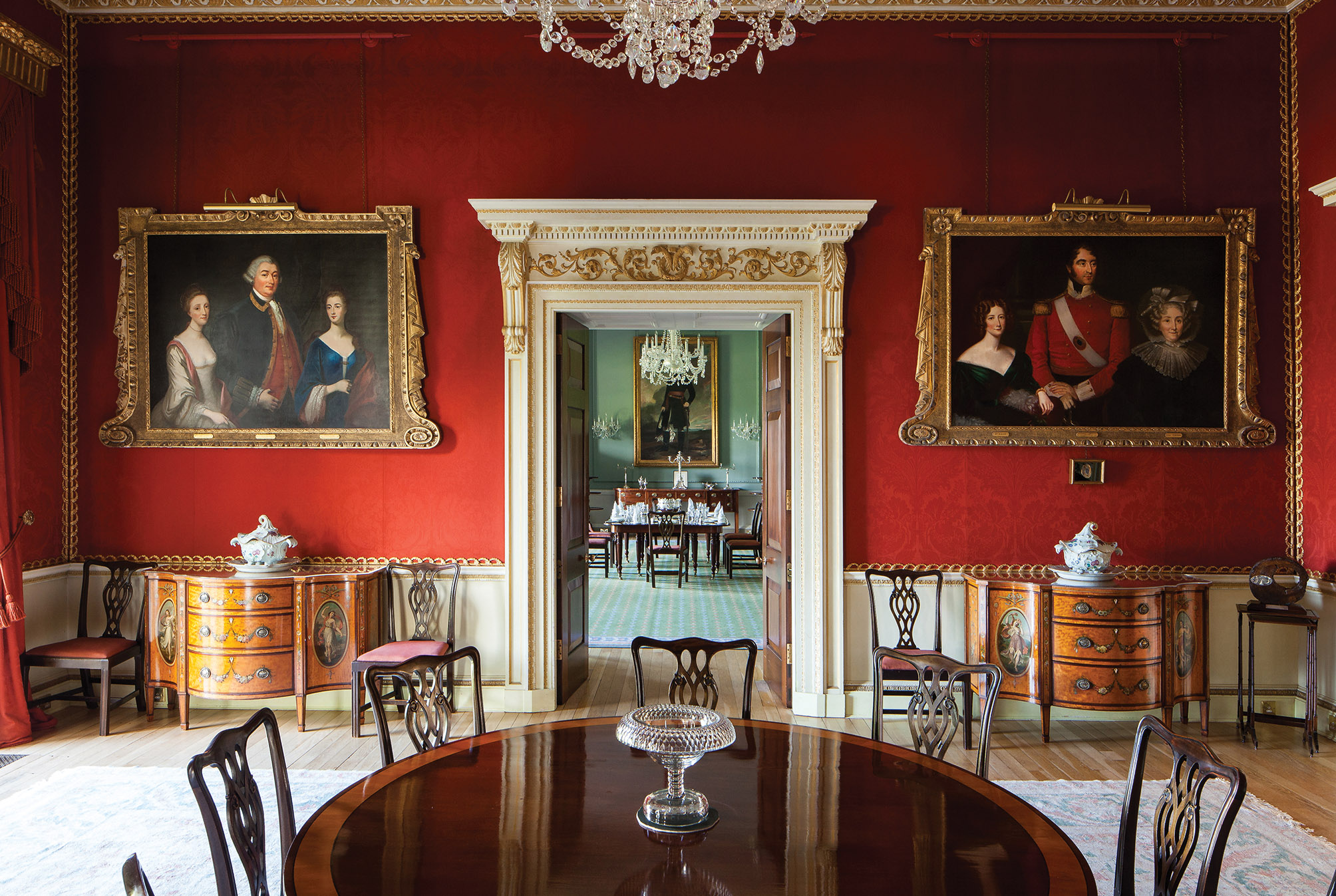 Victorian style room with red wall and very ornate decorations and furniture